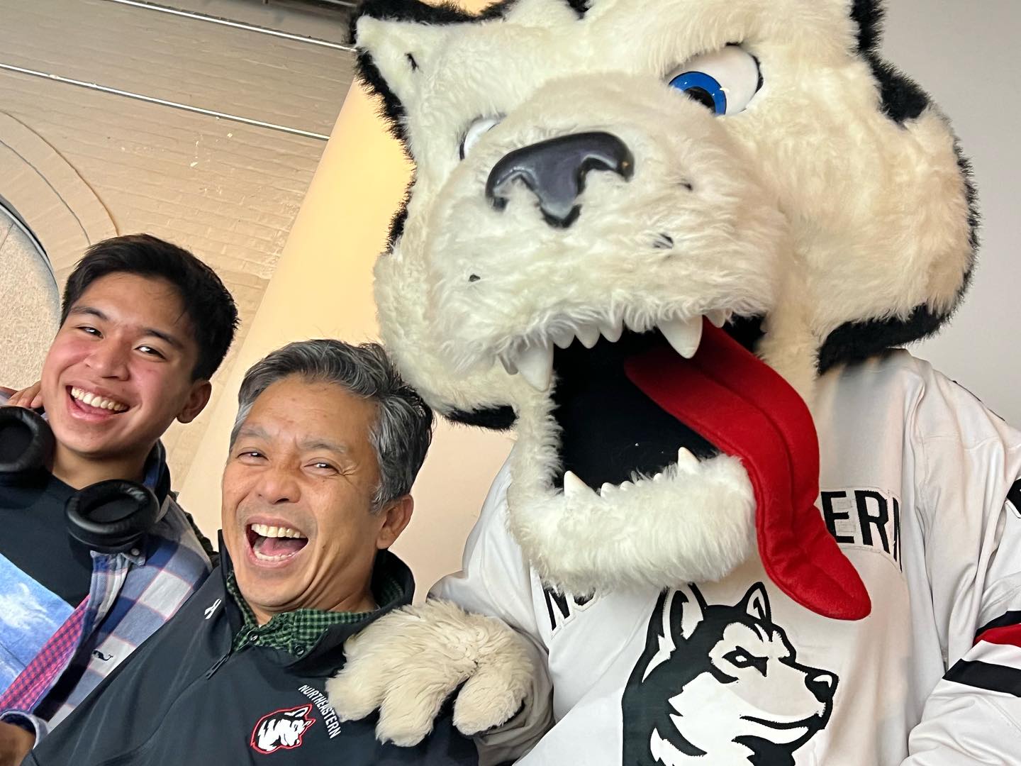 Raphael Sogueco with the Northeastern Husky mascot